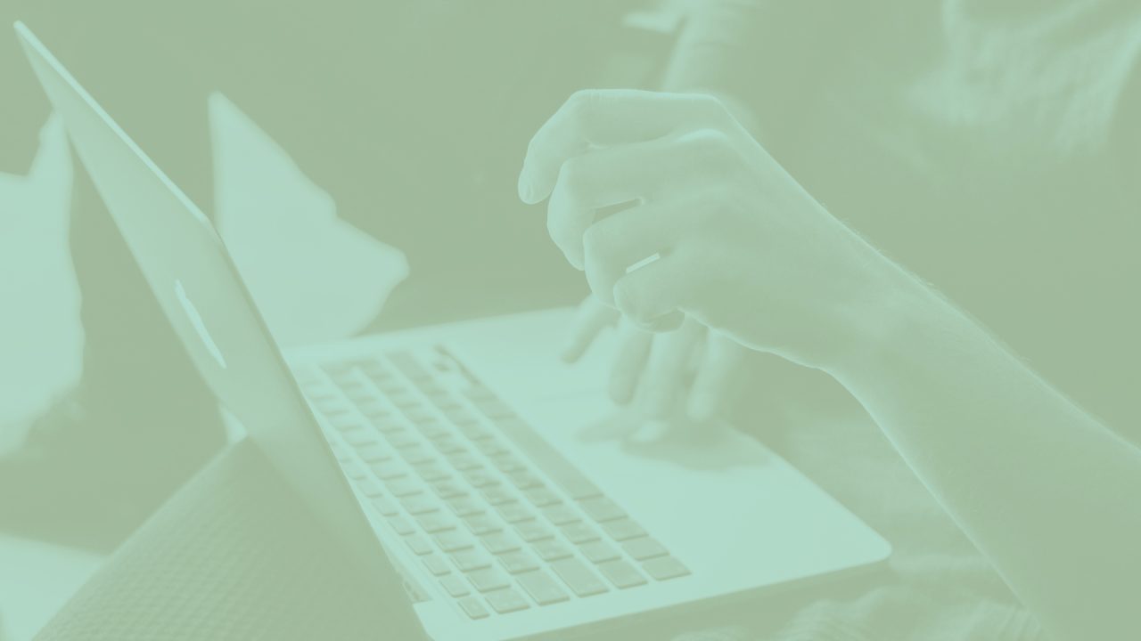 Article banner with a person using touchpad of a laptop