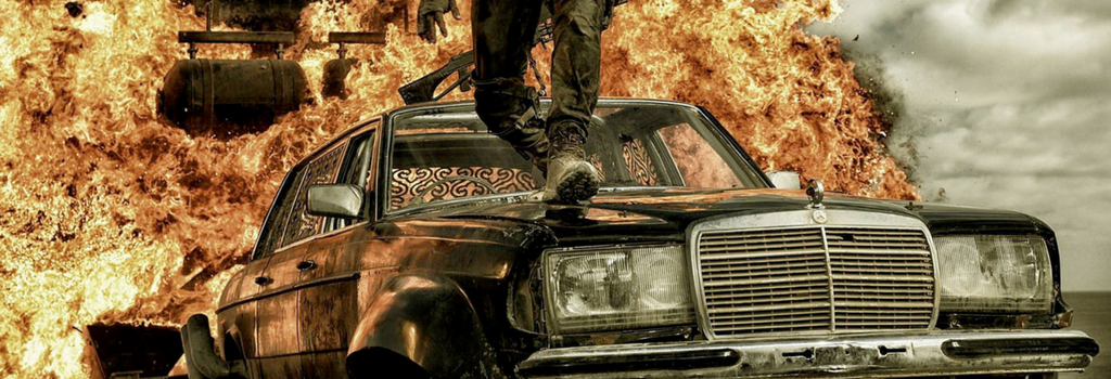 Article banner a man walking on a car and explosion behind