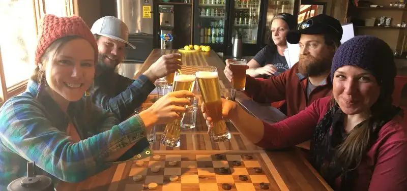 People having beer near a chess board