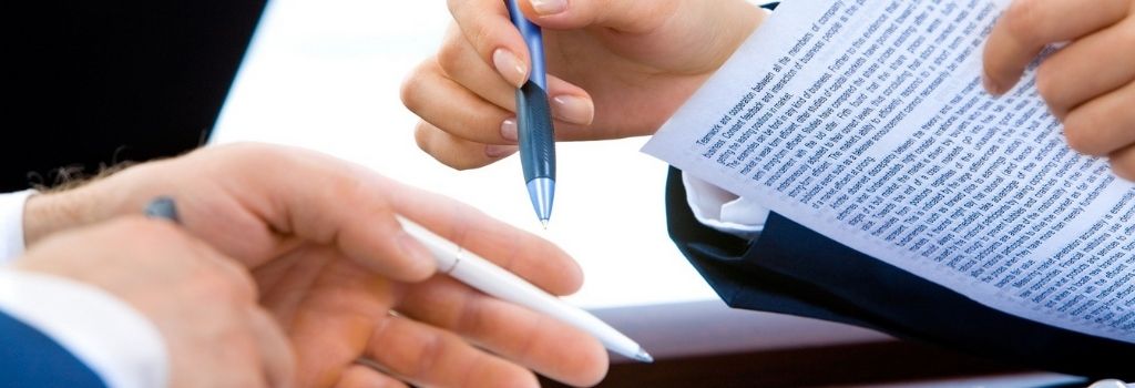 two people reviewing a contract or document